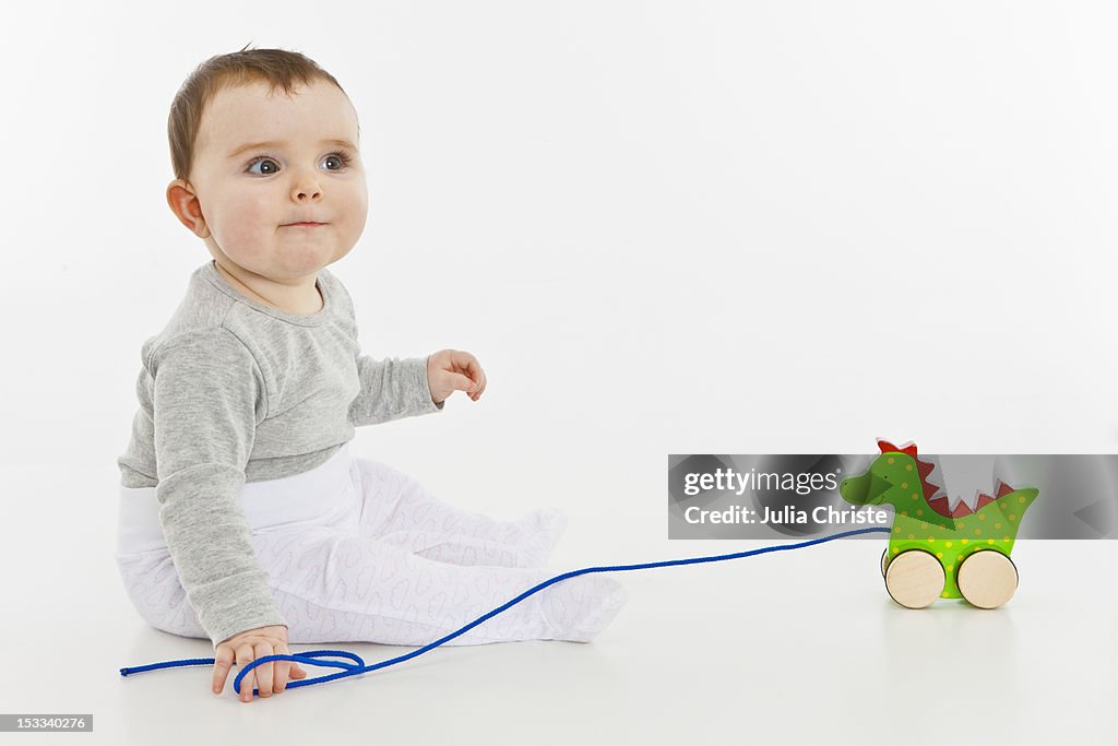 A baby girl with a toy