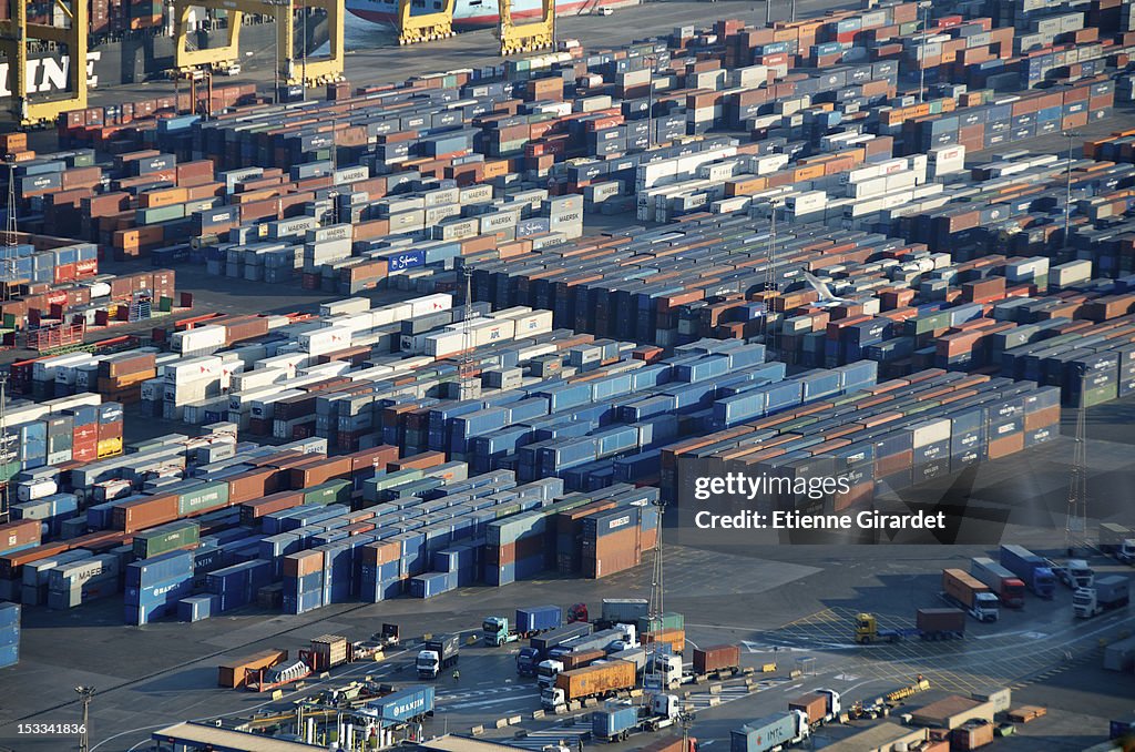 Lorries loading cargo containers at the docks in Barcelona, Spain