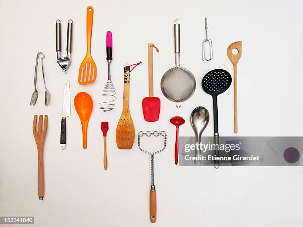 overhead shot of kitchen utensils which appear to be hanging - cooking utensil stockfoto's en -beelden