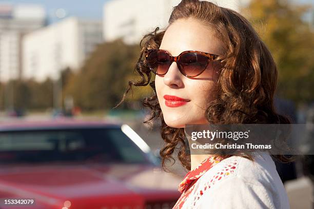 a pretty rockabilly woman standing near a vintage care, focus on woman - rockabilly pin up girls stock pictures, royalty-free photos & images