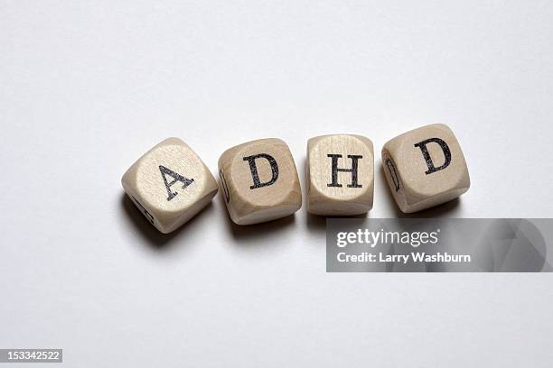 lettered cubes arranged to spell the abbreviation adhd - abbreviation concept stock pictures, royalty-free photos & images