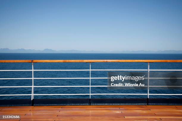 sun shining on the boat deck of a passenger ship, canadian coastline in background - sun deck stock pictures, royalty-free photos & images