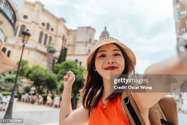 personal perspective of young asian woman taking selfie with camera while travelling - center for asian american media stock pictures, royalty-free photos & images