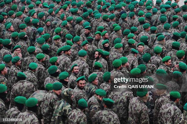 Afghan National Army cadet graduates stand in a group during a graduation ceremony on the outskirts of Mazar-i-Sharif on December 18, 2011....