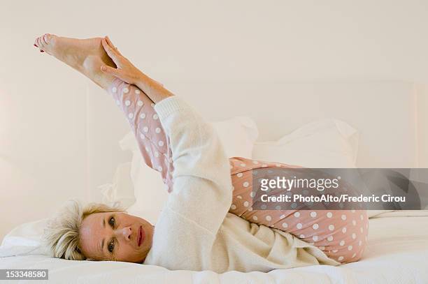 https://media.gettyimages.com/id/153348580/photo/mature-woman-lying-on-bed-stretching-legs.jpg?s=612x612&w=gi&k=20&c=nYIRUtw5wa55wDNWKdQkP1AEKpXZ3wDNo6Di-zRIEHk=