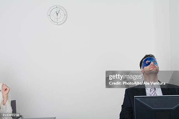 businessman wearing eye mask - computer wearing eye mask stock pictures, royalty-free photos & images