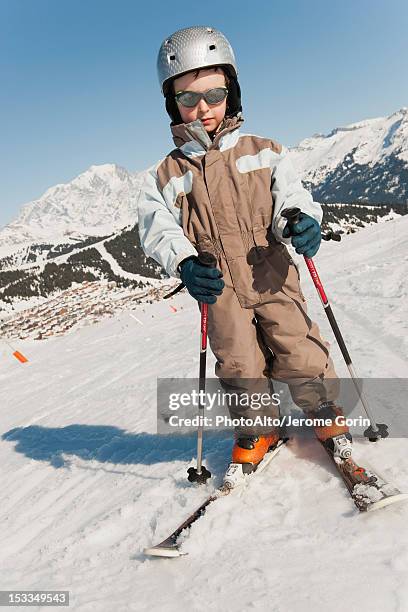 boy in ski-suit, full length portrait - skischoen stockfoto's en -beelden