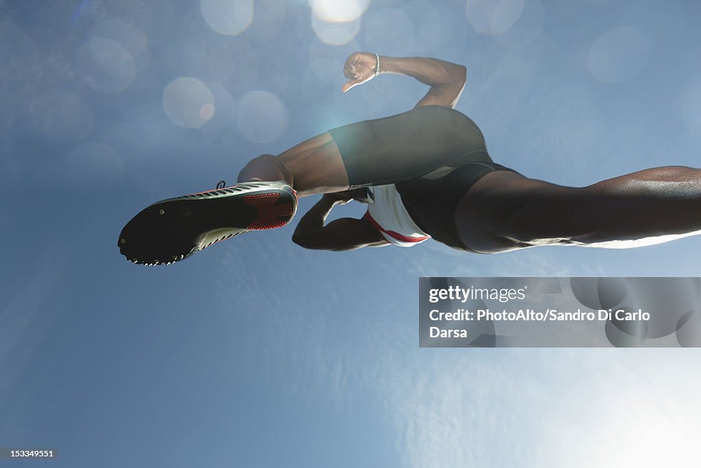 Athlete in midair, low angle view