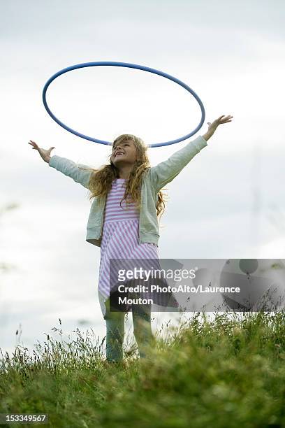 girl throwing plastic hoop in air - ring toss bildbanksfoton och bilder