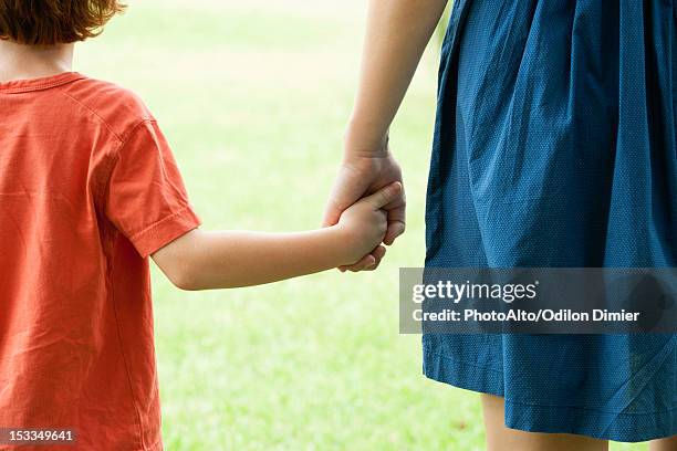boy holding mother's hand, rear view - mom back stock pictures, royalty-free photos & images