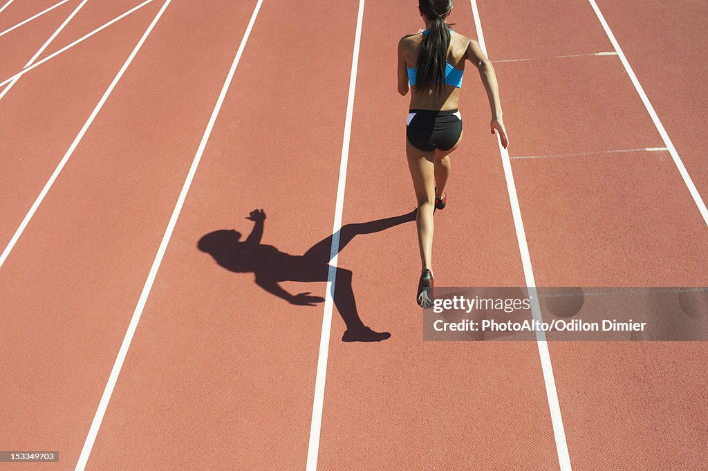 Female athlete running on track