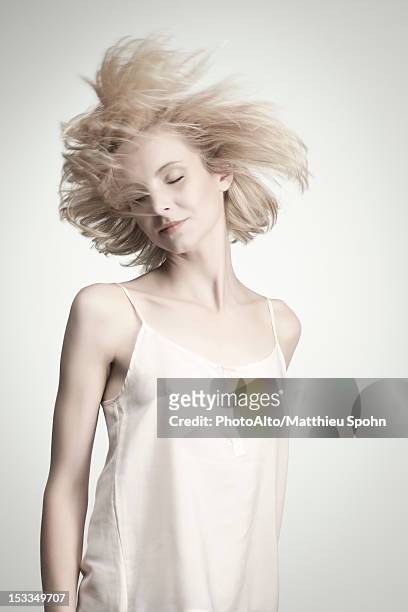 young woman tossing hair with eyes closed - camisola stock-fotos und bilder