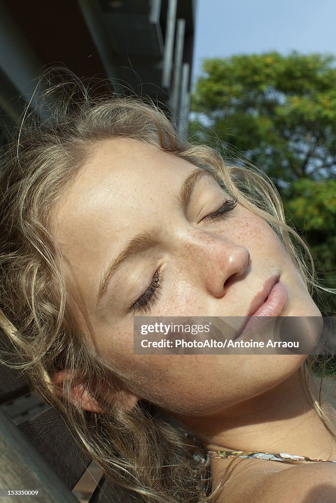 Woman relaxing with eyes closed, portrait