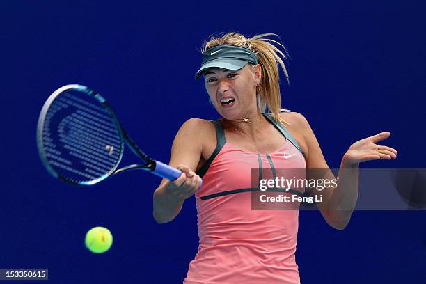 Maria Sharapova of Russia returns a shot to Polona Hercog of Slovenia during the Day 6 of China Open at the China National Tennis Center on October...