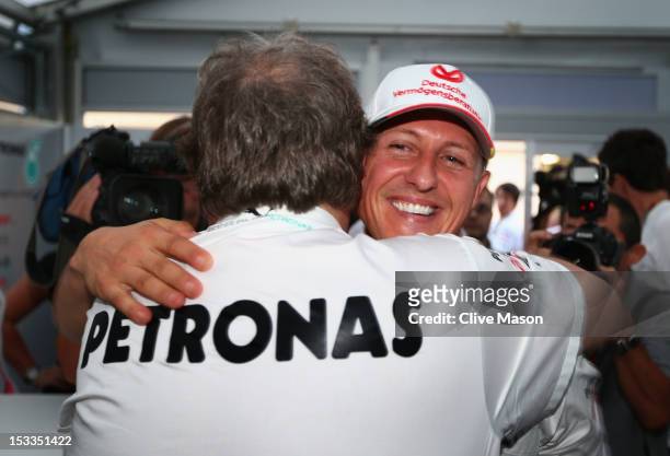 Michael Schumacher of Germany and Mercedes GP embraces Mercedes Motorsport President Norbert Haug after announcing his retirement during previews for...