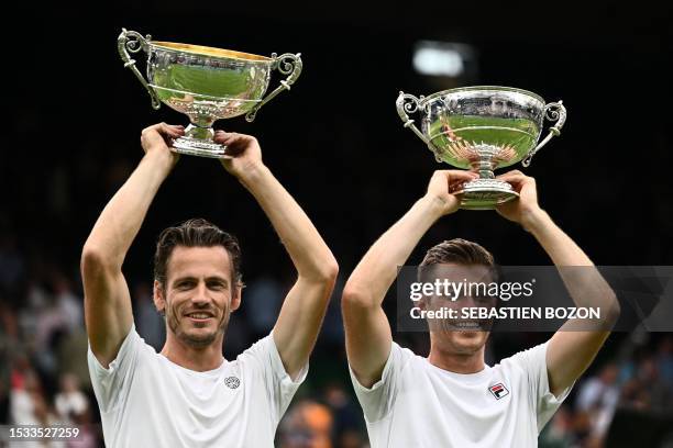 Britain's Neal Skupski and Netherlands' Wesley Koolhof raise their trophies after beating Spain's Marcel Granollers and Argentina's Horacio Zeballos...