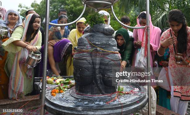 Devotees worshiping Hindu God Shiva on the occasion of Sawan Shivaratri festival at Shri Shri 1008 Baba Ratan Das Prachin Temple at Kadipur village...
