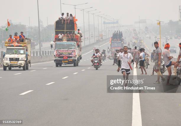 Thousands of Dak Kanwars throng at Delhi-Meerut Expressway on the penultimate day of Kanwar yatra, on July 15, 2023 in Ghaziabad, India.