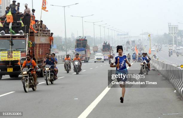 Thousands of Dak Kanwars throng at Delhi-Meerut Expressway on the penultimate day of Kanwar yatra, on July 15, 2023 in Ghaziabad, India.