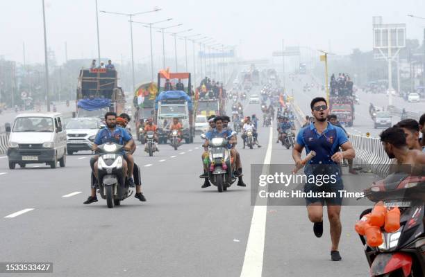 Thousands of Dak Kanwars throng at Delhi-Meerut Expressway on the penultimate day of Kanwar yatra, on July 15, 2023 in Ghaziabad, India.