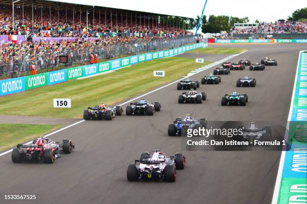 The drivers battle for track position at the start of the race into the first corner during the F1 Grand Prix of Great Britain at Silverstone Circuit...