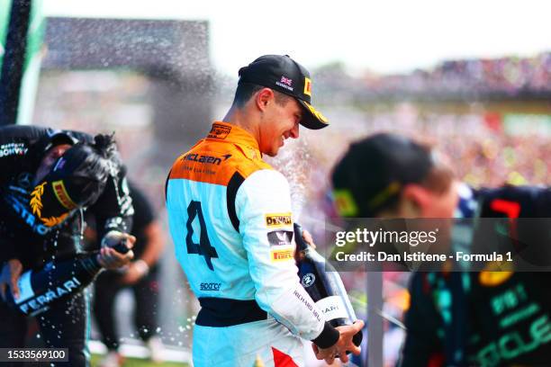 Race winner, Max Verstappen of the Netherlands and Oracle Red Bull Racing, Second placed Lando Norris of Great Britain and McLaren celebrates with...