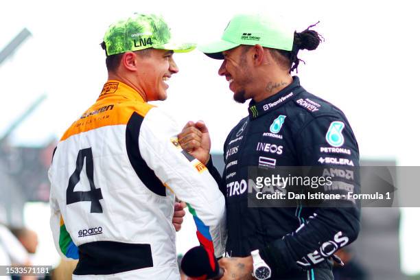 Second placed Lando Norris of Great Britain and McLaren celebrates with third placed Lewis Hamilton of Great Britain and Mercedes in parc ferme...