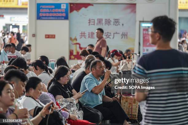 People wait for the train at Guangzhou South Railway Station. Guangzhou South Railway Station is one of the largest and popular railway station in...