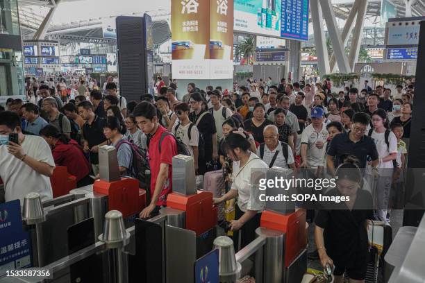 People line up and check in at Guangzhou South Railway Station. Guangzhou South Railway Station is one of the largest and popular railway station in...