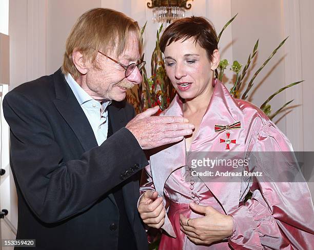 Actress Meret Becker and her father Otto Sander smile at Bellevue Palace on October 4, 2012 in Berlin, Germany. Becker received the Federal Cross of...