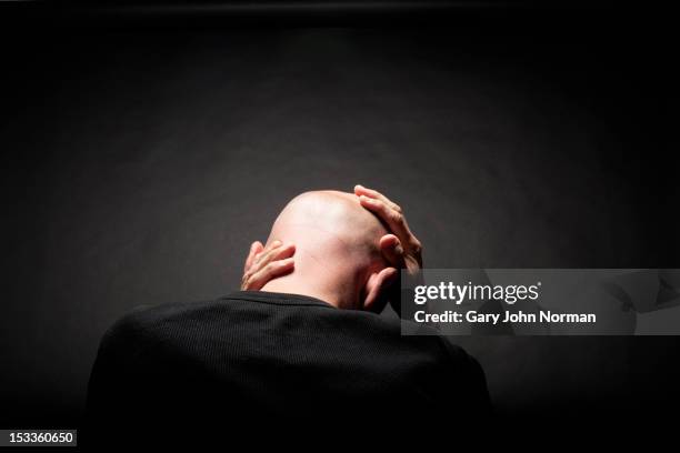 man holding head in hands rear view - 完全に禿げている頭 ストックフォトと画像