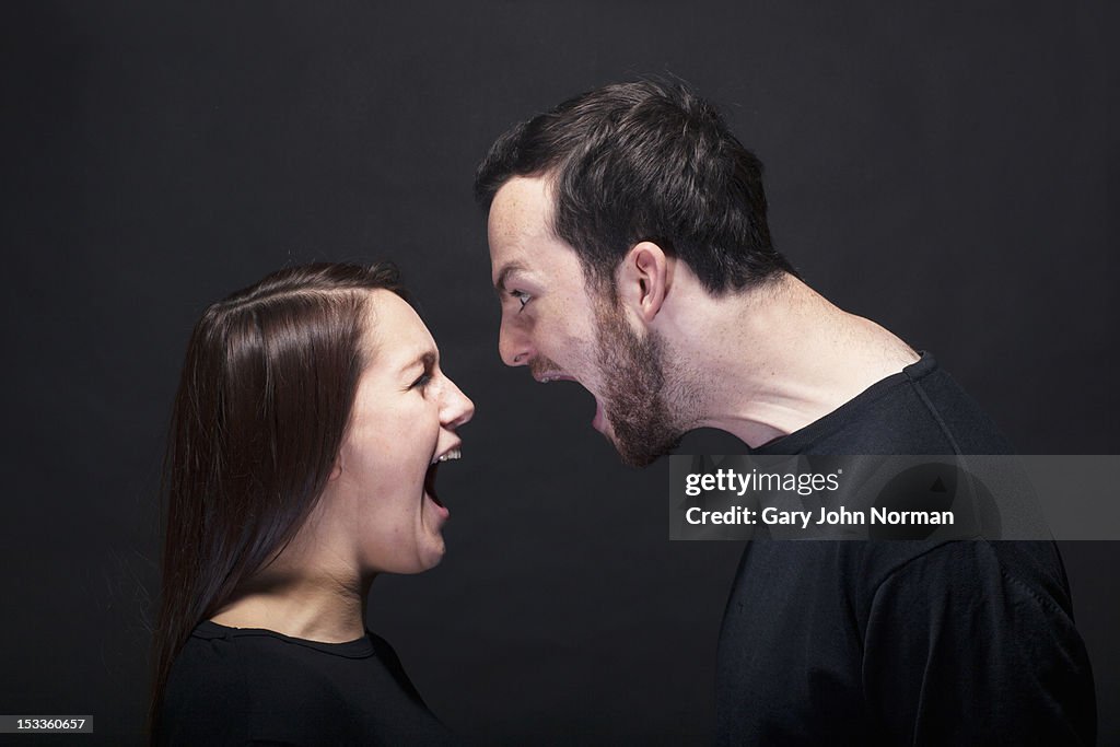 Young man and woman shouting at each other