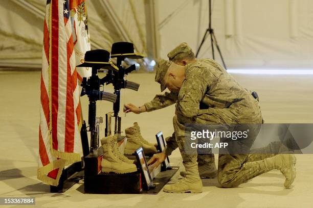 Army soldiers attached to the 1st Squadron ,91st U.S Cavalry Regiment 173d Airborne Brigade Combat Team soldiers pay their respect by the boots, gun,...