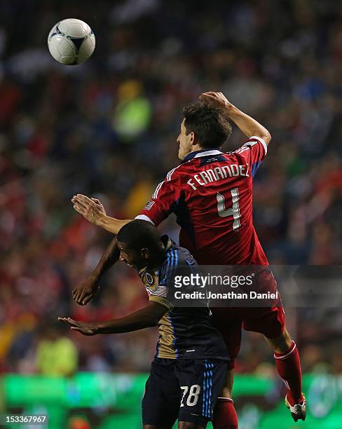 Alvaro Fernandez of the Chicago Fire leaps over Raymond Gaddis of the Philadelphia Union for a header during an MLS match at Toyota Park on October...