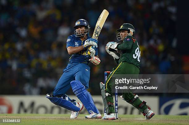 Tillakaratne Dilshan of Sri Lanka hits past Pakistan wicketkeeper Kamran Akmal during the ICC World Twenty20 2012 Semi Final between Sri Lanka and...