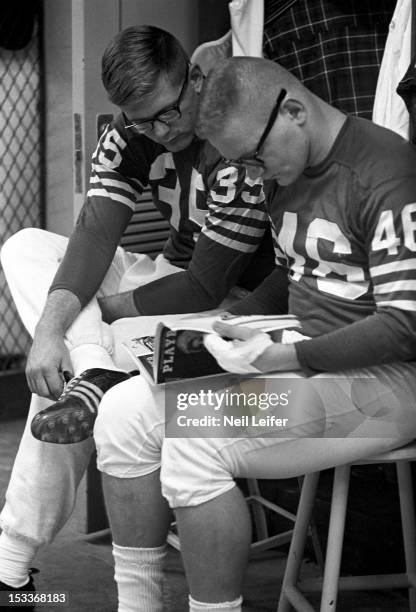 Baltimore Colts Jim Welch and Ted Davis casual, reading Playboy magazine before practice at Memorial Stadium. Baltimore, MD - CREDIT: Neil Leifer