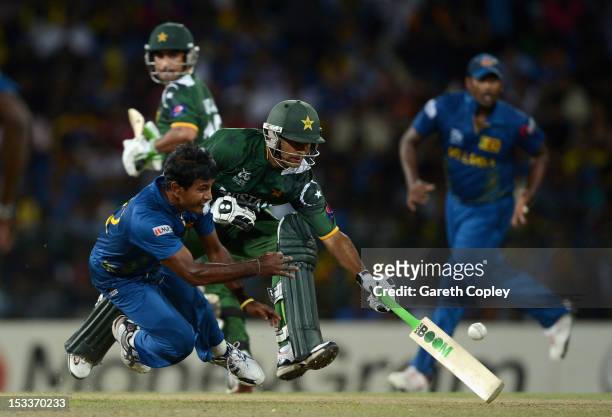 Nuwan Kulasekara of Sri Lanka attempts to run out Mohammad Hafeez of Pakistan during the ICC World Twenty20 2012 Semi Final between Sri Lanka and...