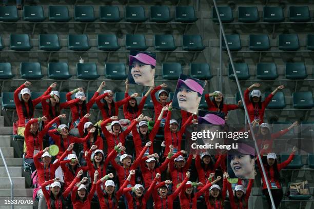 Fans of Na Li of China gestures during her women's singles match against Shuai Peng of China during the Day 6 of China Open at the China National...