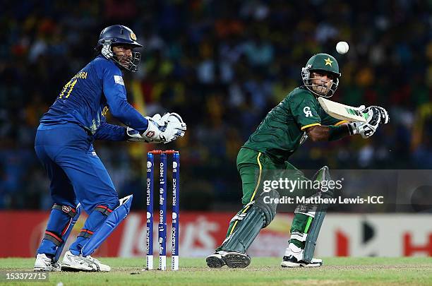 Mohammad Hafeez of Pakistan edges the ball towards the boundary, as Kumar Sangakkara of Sri Lanka looks on during the ICC World Twenty20 2012 Semi...