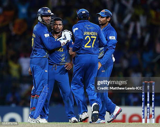 Rangana Herath of Sri Lanka is congratulated, after bowling Shoaib Malik of Pakistan during the ICC World Twenty20 2012 Semi Final match between Sri...