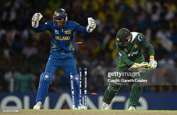 Sri Lanka wicketkeeper Kumar Sangakkara celebrates after Shoaib Malik of Pakistan is bowled by Rangana Herath during the ICC World Twenty20 2012 Semi...