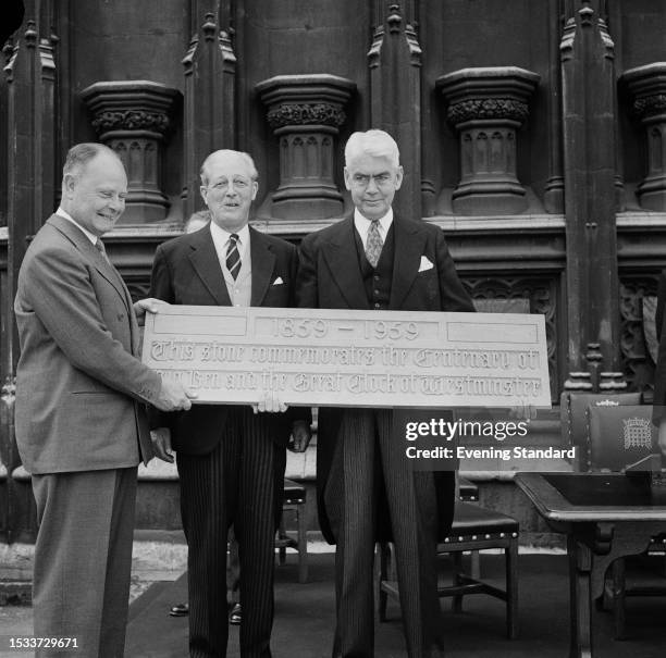 Politicians from left: Hugh Molson , Harold Macmillan and Speaker of the House of Commons William Morrison hold a plaque commemorating the 100th...