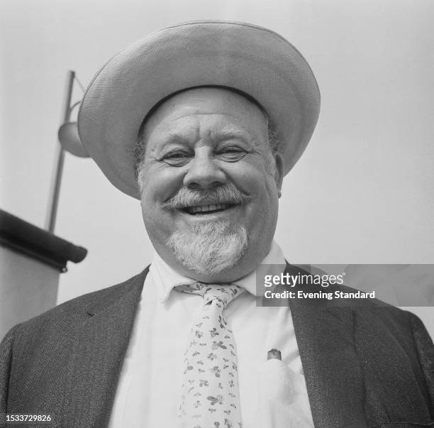 American singer and actor Burl Ives smiling, London Airport, June 11th 1959.