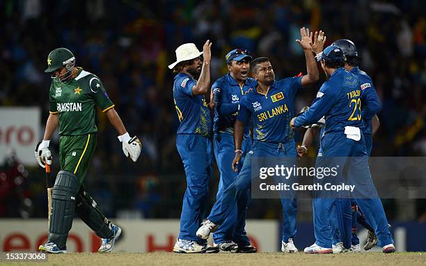 Rangana Herath of Sri Lanka celebrates with teammates after bowling Shahid Afridi of Pakistan during the ICC World Twenty20 2012 Semi Final between...