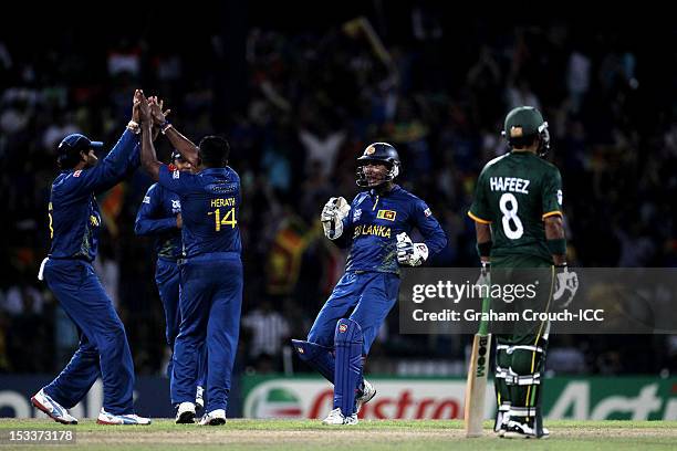 Kumar Sangakkara of Sri Lanka runs to celebrate with team-mates after the dismissal of Shoaib Malik during the ICC World T20 Semi Final between...