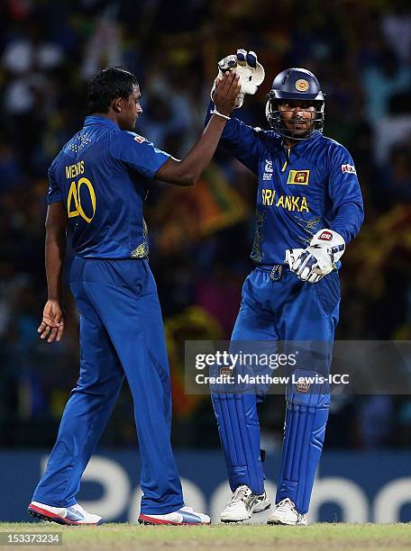 Ajantha Mendis of Sri Lanka is congratulated by Kumar Sangakkara, after Sohail Tanvir of Pakistan was stumped during the ICC World Twenty20 2012 Semi...