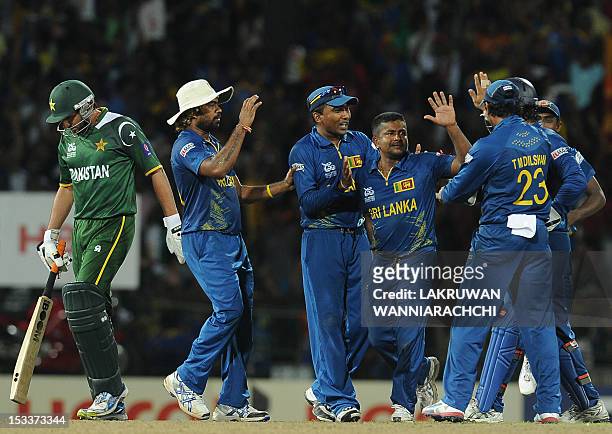 Sri Lankan spinner Rangana Herath celebrates with his teammates after he dismissed Pakistan's Shahid Afridi during the ICC Twenty20 Cricket World...