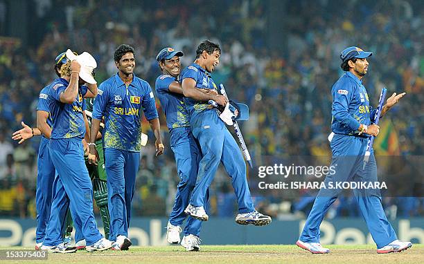 Members of the Sri Lanka cricket team celebrate after beating Pakistan during the ICC Twenty20 Cricket World Cup's semi-final match at the R....