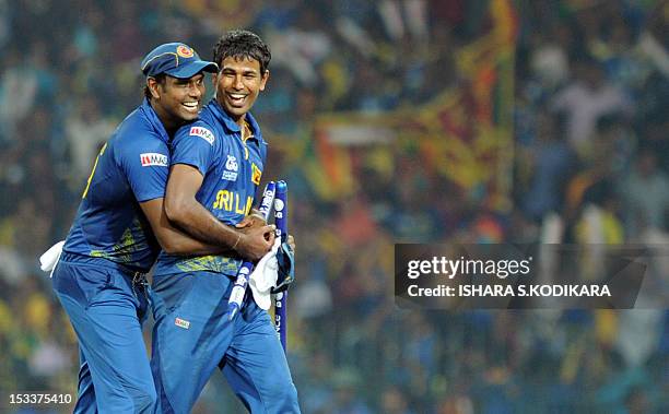 Sri Lanka cricketers Nuwan Kulasekara and Angelo Mathews celebrate after beating Pakistan during the ICC Twenty20 Cricket World Cup's semi-final...