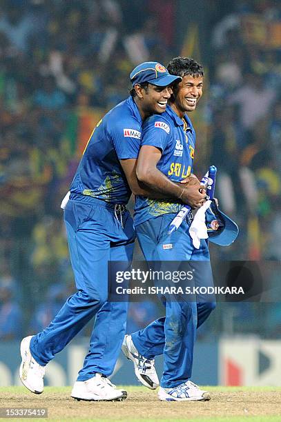 Sri Lanka cricketers Nuwan Kulasekara and Angelo Mathews celebrate after beating Pakistan during the ICC Twenty20 Cricket World Cup's semi-final...